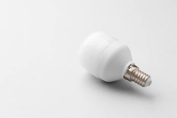 Light bulb on light grey paper background