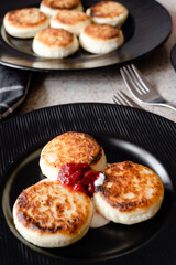 cheesecakes with strawberry jam on a plate