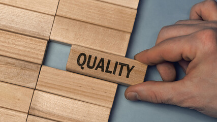 QUALITY word concept. Close-up wooden piece blocks on the table