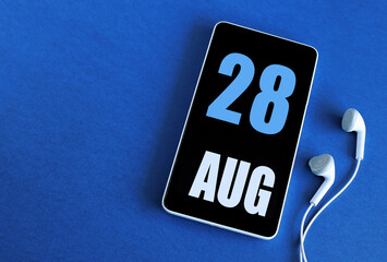 August 28. 28 st day of the month, calendar date. Smartphone and white headphones on a blue background. Place for your text. Summer month, day of the year concept