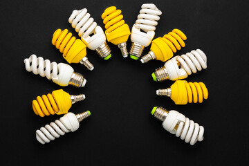 White and yellow light bulbs on black background