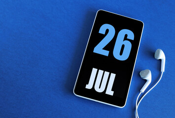 July 26. 26 st day of the month, calendar date. Smartphone and white headphones on a blue background. Place for your text. Summer month, day of the year concept