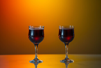 Two glasses of red wine on the fantastic sunset background