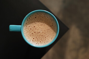 Top view Earl Grey milk tea at the edge of a table