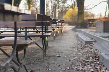 Empty benches and tables in beer garden due to restaurant closure. No customers during the Covid-19 Coronavirus pandemic.