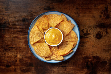 Nacho chips with a cheese dip, overhead shot