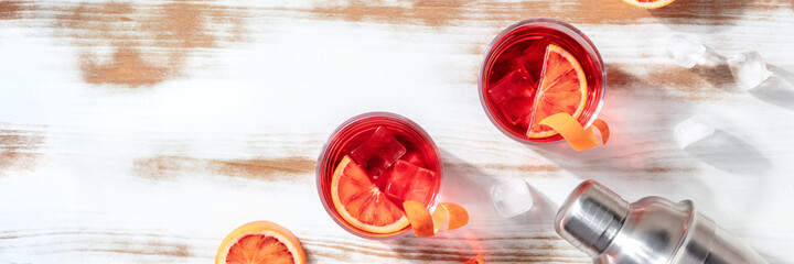 Negroni cocktails panorama with blood oranges and a place for text or logo