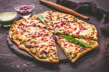 Tart flambee (Flammkuchen) with ramson sour cream, onion and bacon