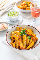 Homemade baked potato wedges with garlic dip