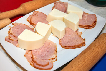 Cheese and ham prepared for making pizza. Close-up, selective focus