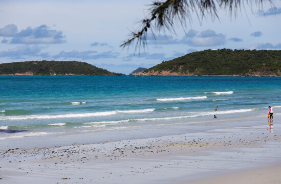 Touris walk on the beach and swimming in the sea at Nam Sai beach, Sattahip Thailand.