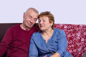 Love lives forever. Senior couple at home. Handsome old man and attractive old woman hugging and...