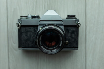 Old camera with photographs on a gray concrete background