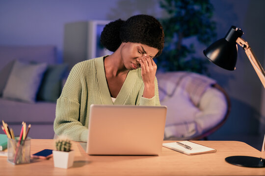 Portrait of attractive tired girl using laptop studing late evening hard work profession in flat house living-room indoor