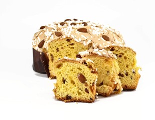 Colomba Pasquale, typical italian easter cake,with some slices in front. The name means Easter Dove in english language, due to its shape. White background.