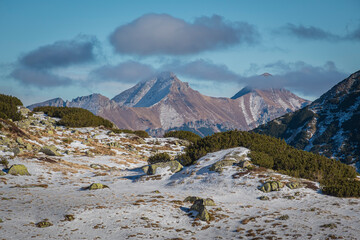 Clouds over the peaks of High Tatras, Slovakia. The view from the Polish side of Tatra National Park. Selective focus on the rocks, blurred background.