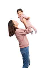 Portrait of pretty caucasian mother with daughter isolated on white studio background. Young attractive woman holding adorable child up in arms, baby girl looking at camera, happy childhood concept.