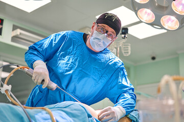 surgeon during liposuction in the operating room