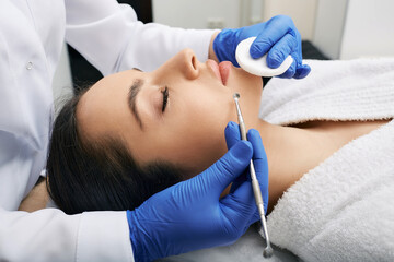 Facial cleansing. Beautiful woman having mechanical cleansing face skin from defect and remove blackhead
