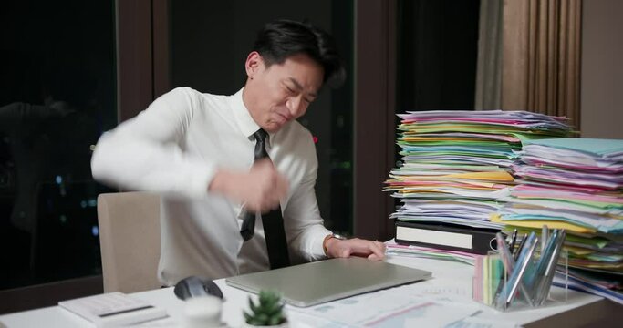 angry businessman hit his laptop