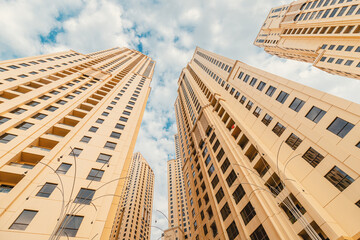 Fototapeta premium Residential real estate buildings and urban development in Dubai, UAE - bottom-up view