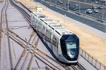 Hightech modern automated tram rides on the Sheikh Zayed Highway in Dubai, aerial view. Concept of...