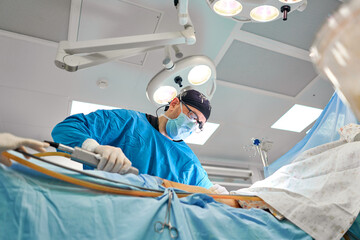 surgeon during liposuction in the operating room