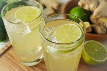 Glasses of ginger beer on cutting board, close up