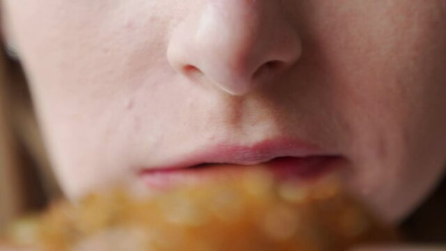 Close-up hands woman eating hamburger junk food fast food 