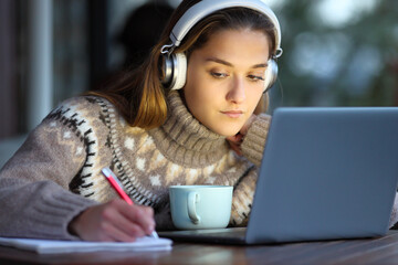 Student e-learning in a coffee shop in winter