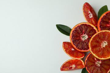 Red orange slices with leaves on white background, space for text