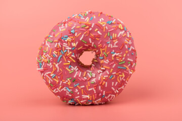 Fresh made Donuts isolated on pink background. Doughnuts are traditional sweet pastries. Copy space for text.