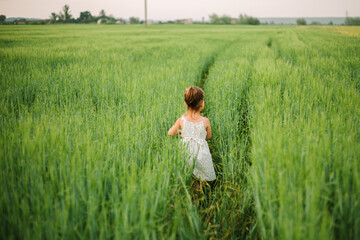 girl playing in the field. summer time. childhood.