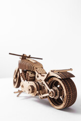 Wooden toy-motorcycle designer on a white background