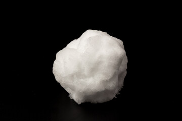 Heap of white snow on black background.The structure of snow and ice. Close-up.