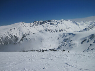 Snowy mountain peaks in sunny weather