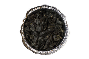 Sunflower seeds in a cup of foil on a white background