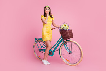 Full length body size view of nice attractive cheerful girl walking riding bicycle enjoying spare time isolated on pink color background