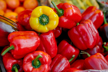 Distinction concept. Stand out from the crowd. Bell pepper background