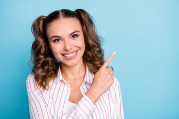 Portrait of attractive cheerful brown-haired girl demonstrating copy space new solution isolated over vivid blue color background