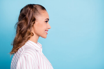 Fototapeta premium Side profile photo portrait cute nice pretty female student smiling looking blank space isolated vivid blue color background