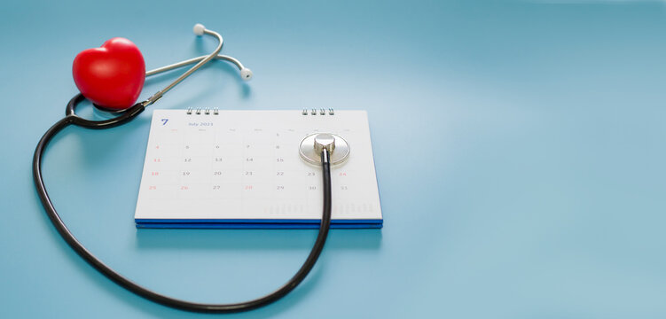 Stethoscope with date on the calendar page on a blue background Health care concept.