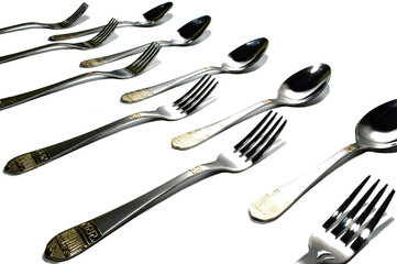 cutlery on white background, forks and spoons