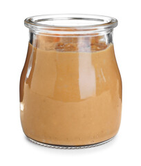Delicious peanut butter in glass jar isolated on white