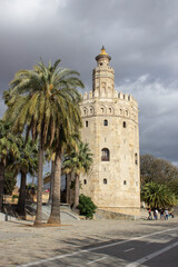 Fototapeta na wymiar The Golden tower at the Guadalquivir in Seville is one of Seville's iconic landmarks. It´s a military observation tower built by the Almohads in the 12th century and was part of the Moorish city wall