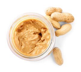 Glass jar with tasty peanut butter on white background, top view