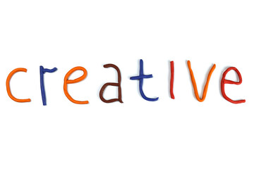 word creative made of colored plasticine isolated on white
