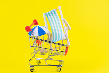 Vacation travel tour sale concept. Tourism opening. Sun lounger and summer umbrella in a shopping...