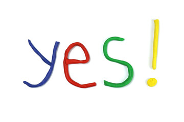 Yes word made of colored plasticine isolated on white