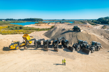 Aerial shot of a quarry with workers and machinery digging sand